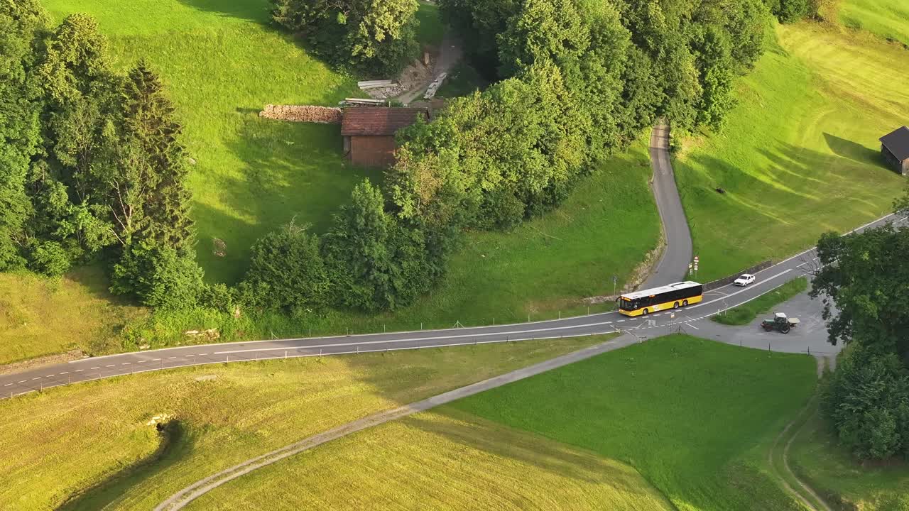 Aerial view of a bus on a road in a rural landscape