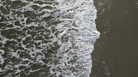 Waves-Crash-from-Left-to-Right,-Aerial-Drone,-Oak-Island,-NC