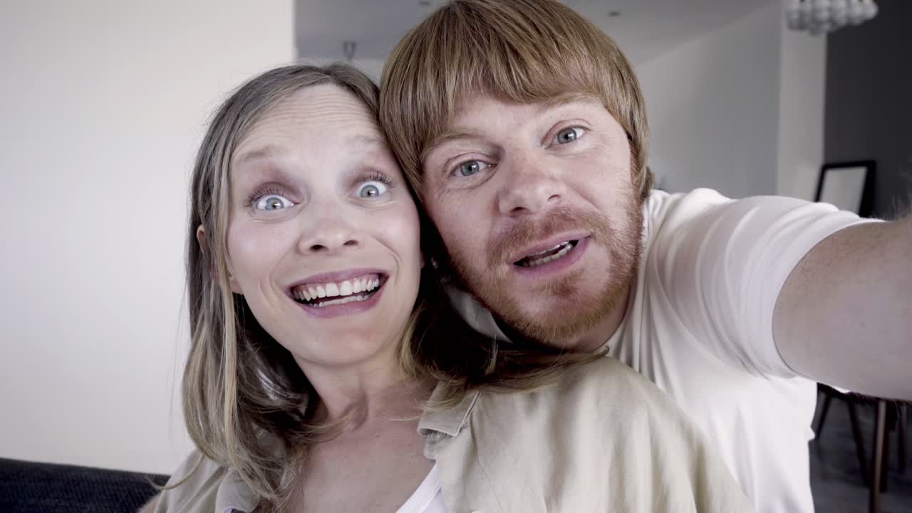 Smiling married couple having video call