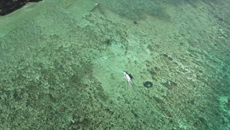 Aerial-Shot-of-A-Small-Boat-On-Top-Of-A-Clear-And-Beautiful-Sea-In-The-Philippines-4K