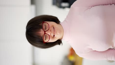 portrait of kid with special needs smiling at camera at home