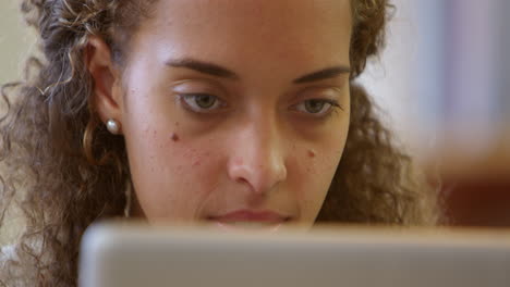 Businesswoman-Using-Laptop-At-Desk-In-Office-Shot-On-R3D