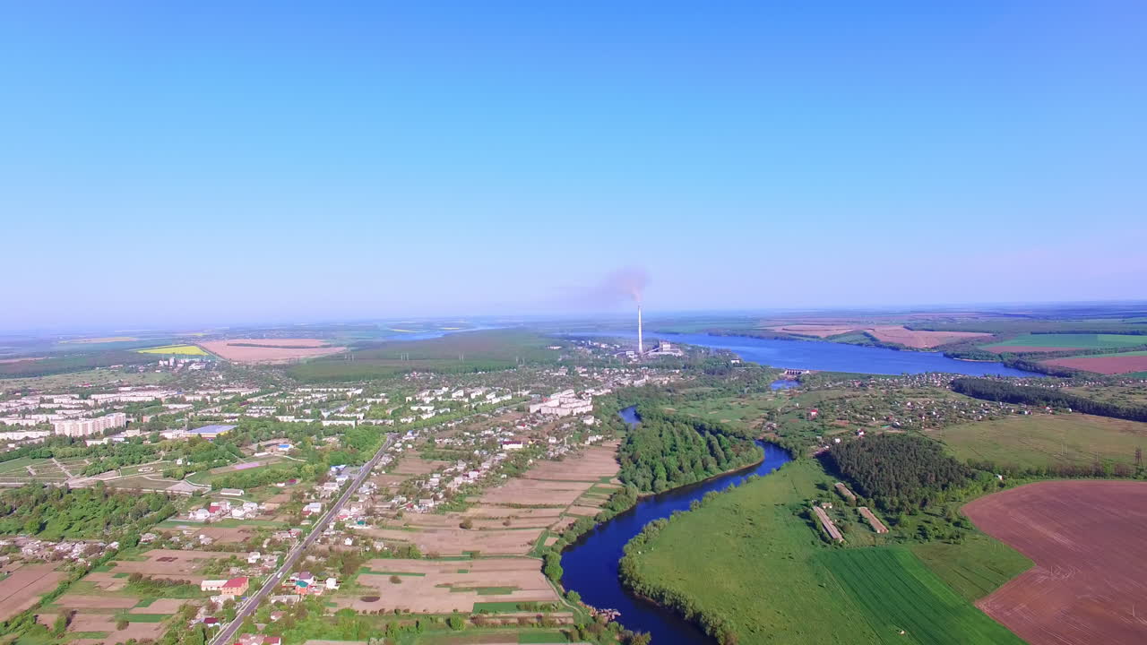 Scenic picture of the big city on beautiful sunny day. Fantastic view of blue river flowing near the metropolis.