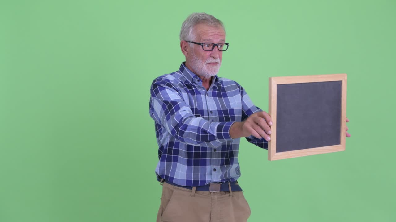 Handsome senior bearded hipster man