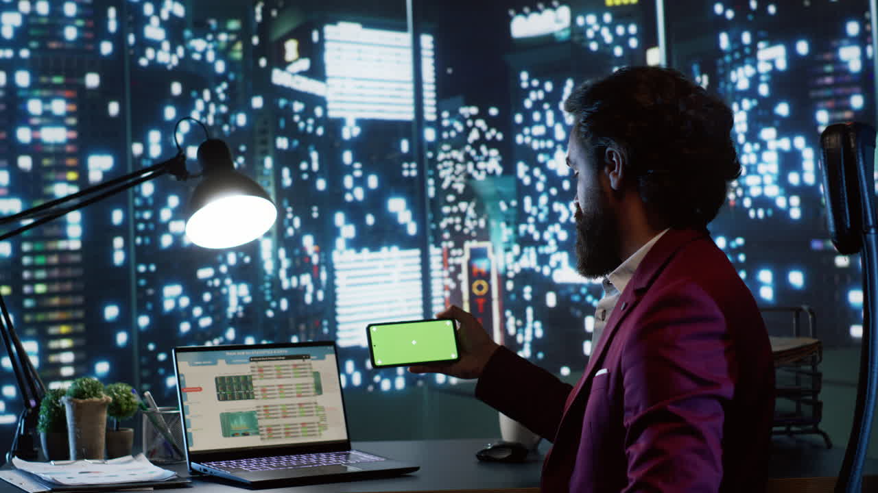 Shareholder checks greenscreen on mobile device display