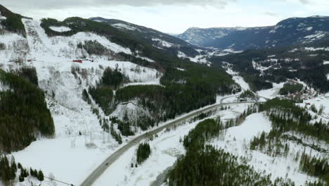 Snow-Covered-Landscape-And-Mountainside-In-Haugastol-Norway---aerial-shot