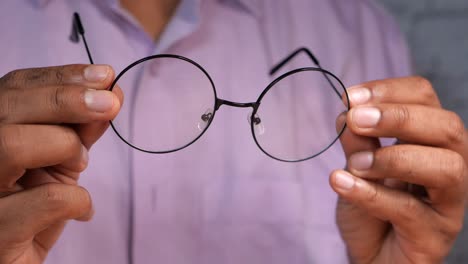 person holding round glasses