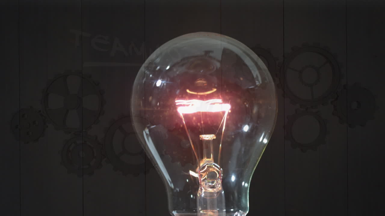 Animation of bulb lightening over brown background with gears