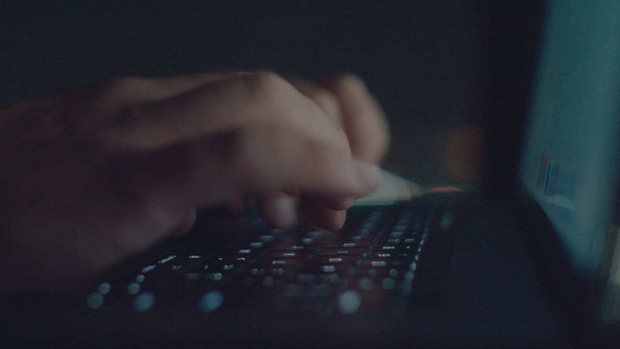 White hands typing text at night