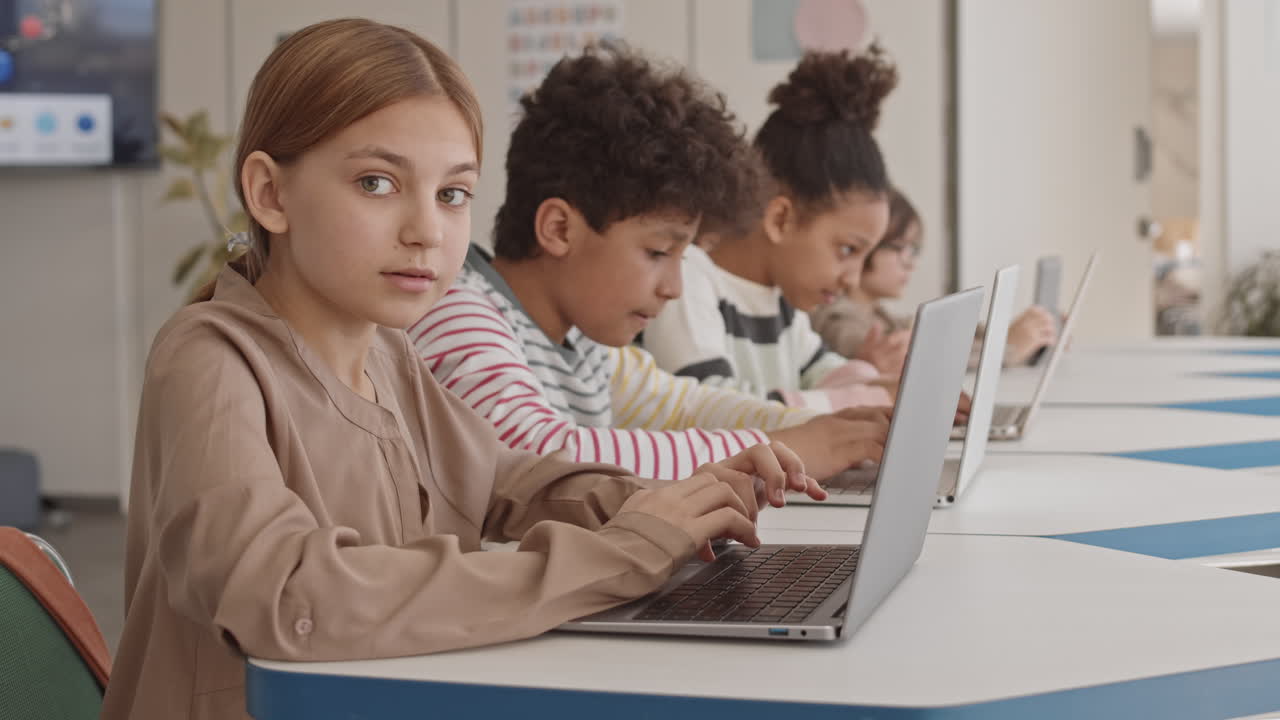 Pretty Schoolgirl with Laptop at IT Class