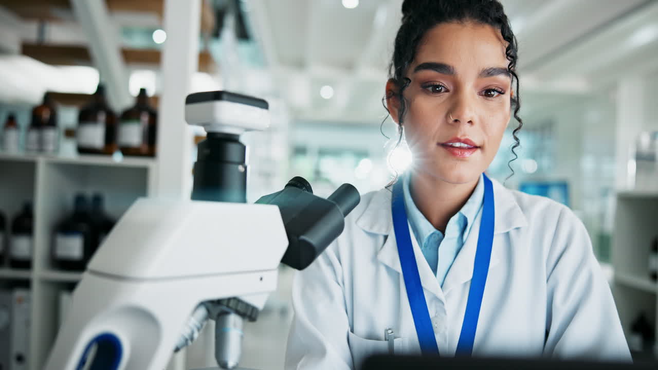 Scientist using a microscope in a laboratory