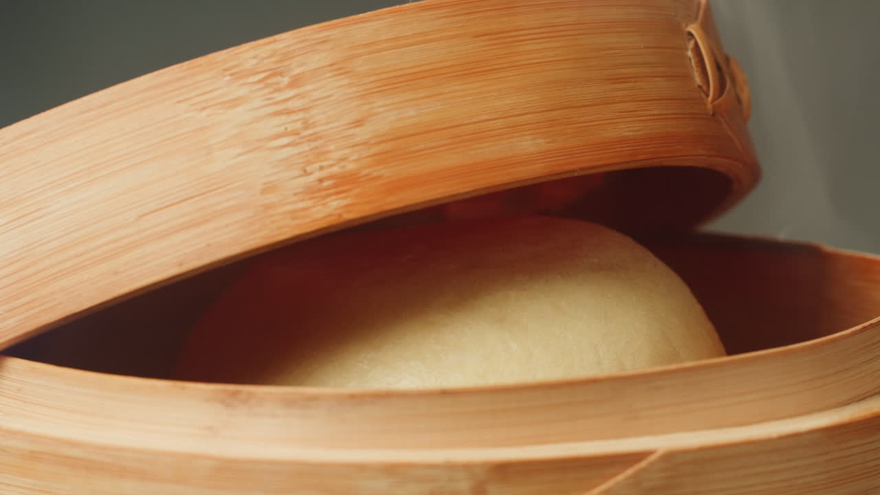 Freshly Steamed Bun in a Traditional Bamboo Steamer