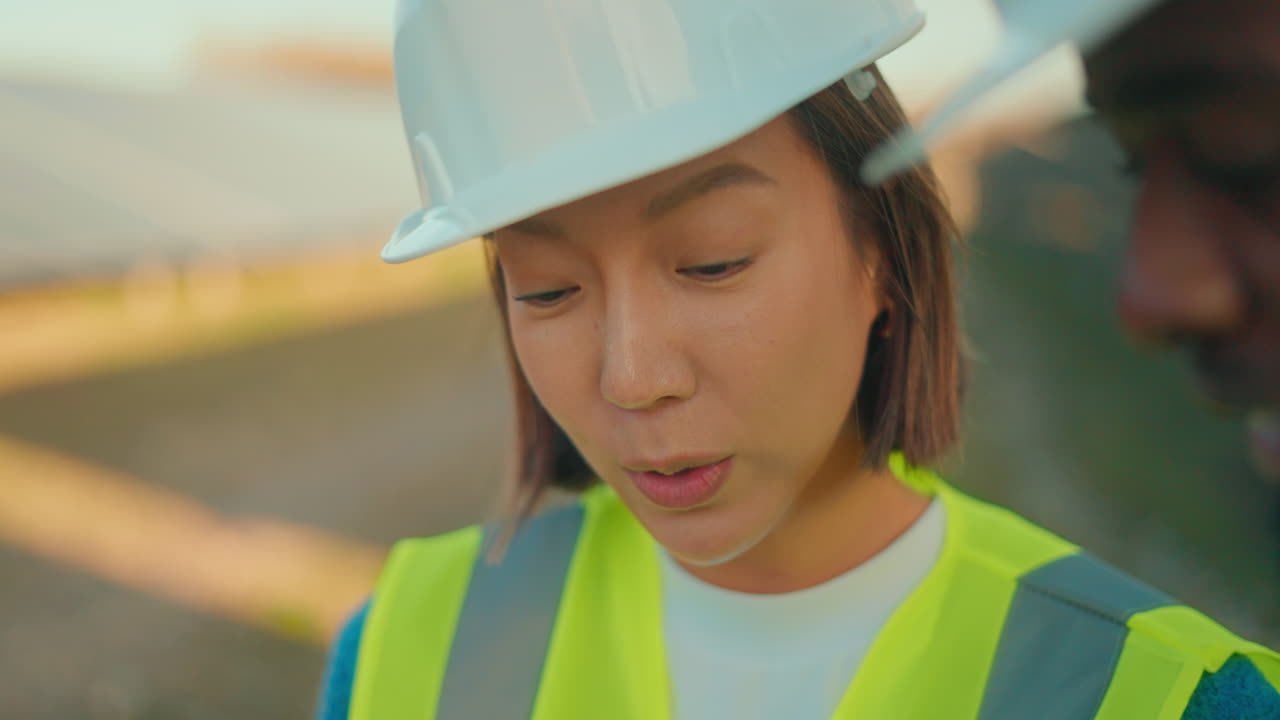 Construction worker inspecting solar panels