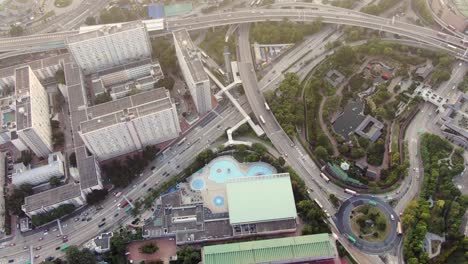 Downtown-Hong-Kong-daily-traffic-surrounded-with-city-skyscrapers,-Aerial-view