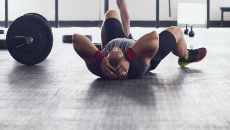 man exhausted after workout in gym