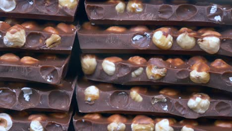 close-up of stacked chocolate bars with hazelnuts