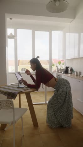 woman having a video call in a kitchen