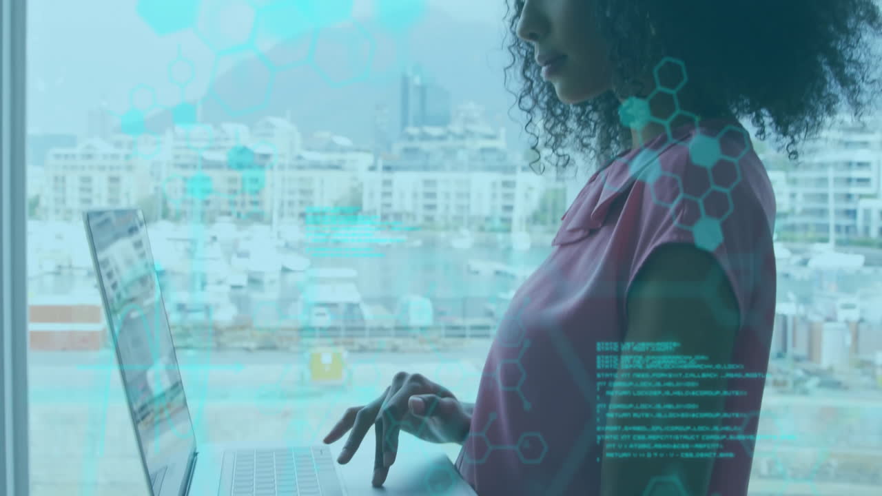 Woman using laptop by window with digital network animation overlay