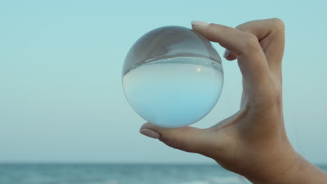 transparent glass ball in hand