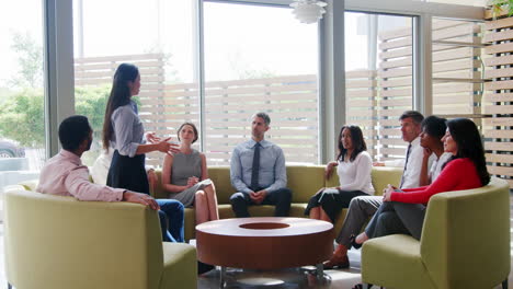 asian businesswoman presenting a team meeting in lounge area