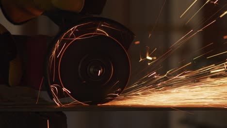 construction worker grinding metal and making sparks, closeup