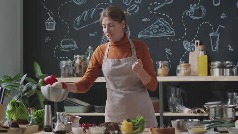 woman cooking and preparing salad in a kitchen