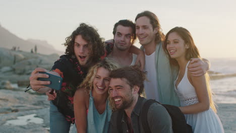 happy group of friends taking selfie at beach