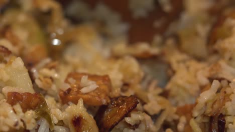 wooden spoon mixes fried rice vegan close up