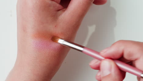 applying blush with a makeup brush