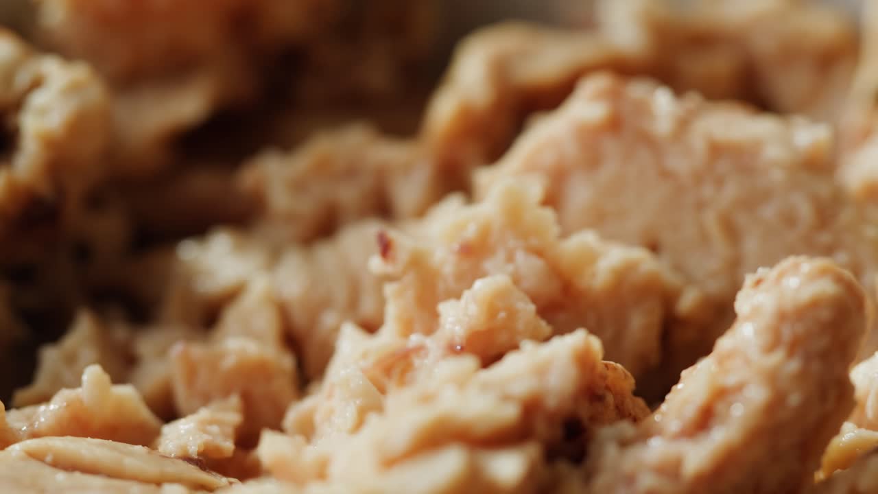 Smoked cod liver in oil in open tin can with fresh greens on wooden table. Seafoods delicacy. High quality 4k footage