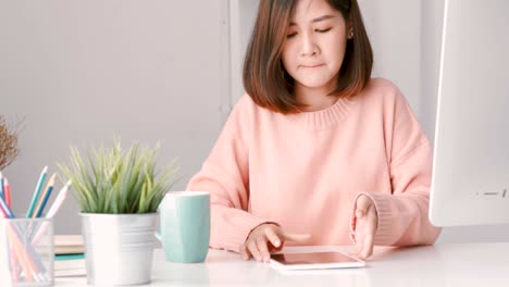 young asian woman successful businesswoman using tablet at home office. happy cheerful smiling.