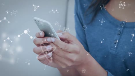 animation of molecules over woman using smartphone