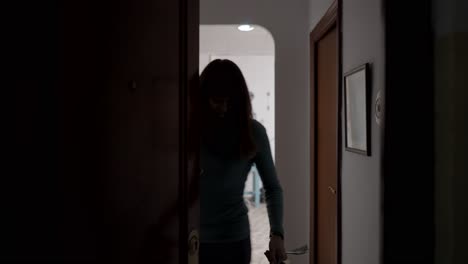 woman walking through hallway