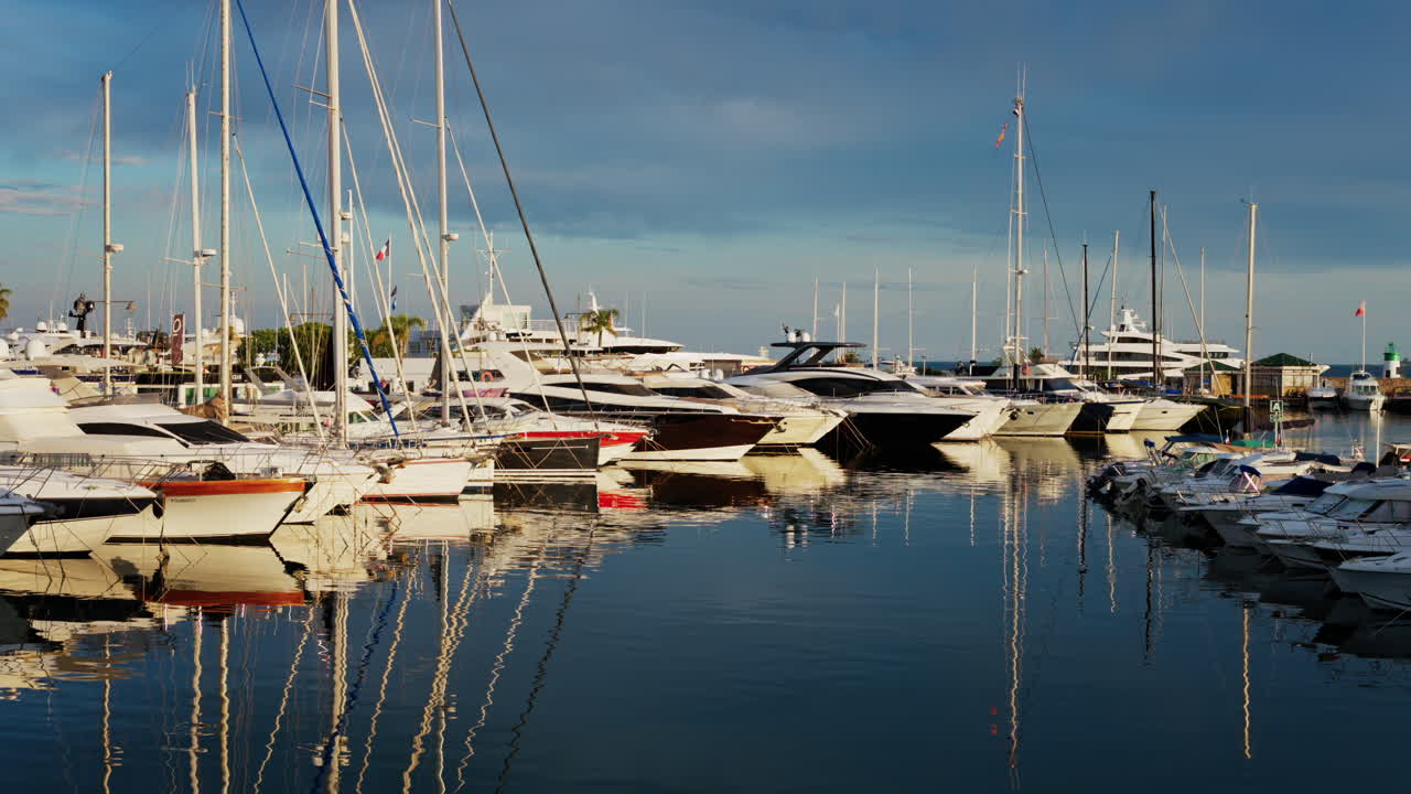 Antibes, France - May 23, 2025: Multiple white boats docked in the Port Vauban on a cloudy day