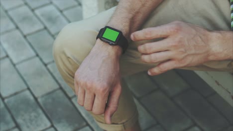 hombre con un reloj inteligente con una pantalla verde