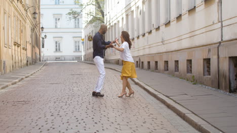 interracial couple dancing bachata in the old town street 11