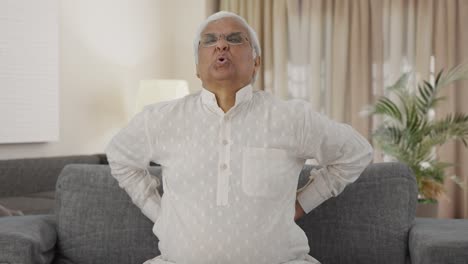 sick indian old man suffering from back pain