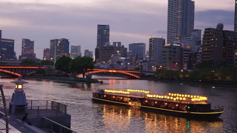 nakanoshima cruise through osaka city at night, urban background in summer