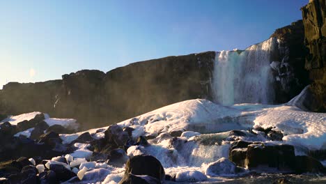 oxararfoss, the famous waterfall in thingvellir national park in iceland nearby reykjavik city. it is streaming hardly and some part of its frozen and freeze as glacier, video 4k