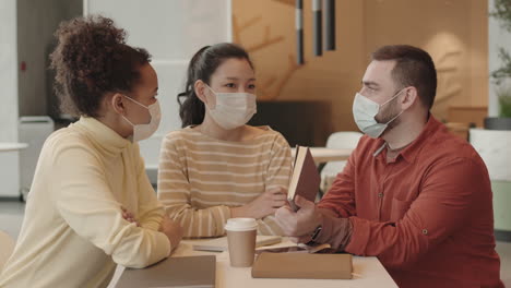 colleagues having discussion in coffee shop