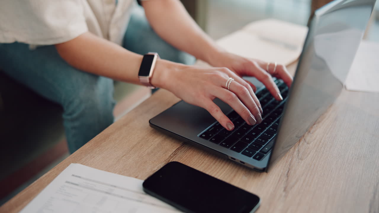 Woman Typing on Laptop at Home Office