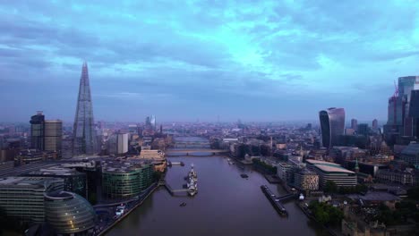 aerial view of famous london skyline along river thames in blue late afternoon