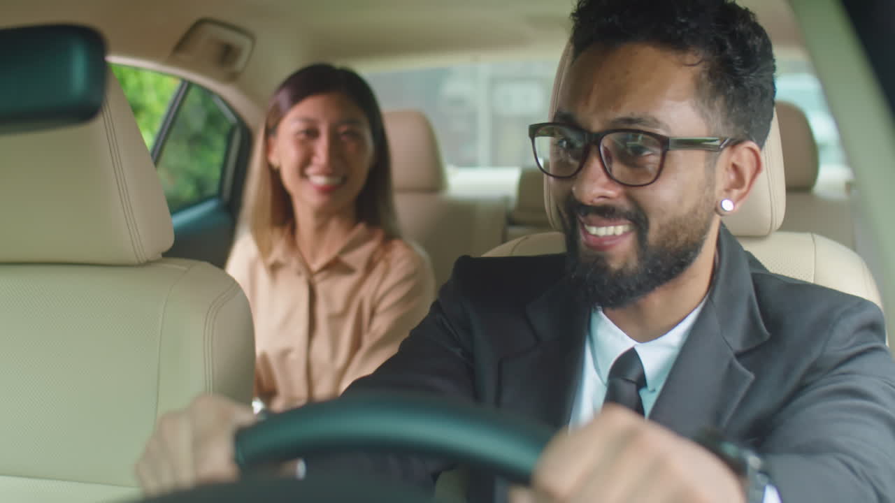 Businesswoman Speaking with Personal Driver in Car