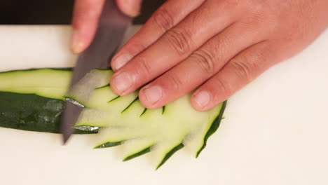 slicing fresh cucumber with style - sushi plate decoration - close up, slow motion