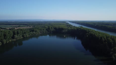 beautiful drone three-sixty footage over a natural lake next to the rhine river in central europe