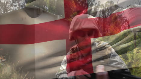 animation of flag of england over caucasian male soldier with rifle