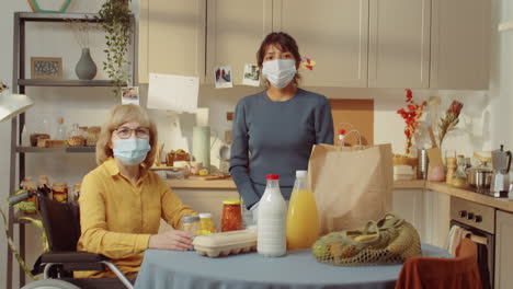 Volunteer-And-Senior-Woman-In-Kitchen