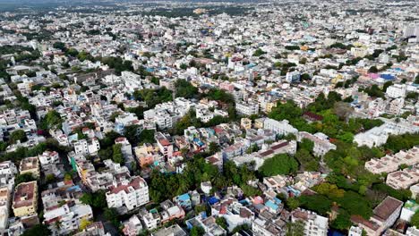 moving down high-angle aerial shot captures a sprawling view of puducherry. the urban landscape is dense, with a mix of buildings of varying sizes and colors filling the frame