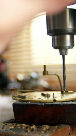 horologist using drill machine