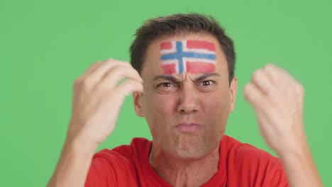 man with norwegian national flag upset with a referee